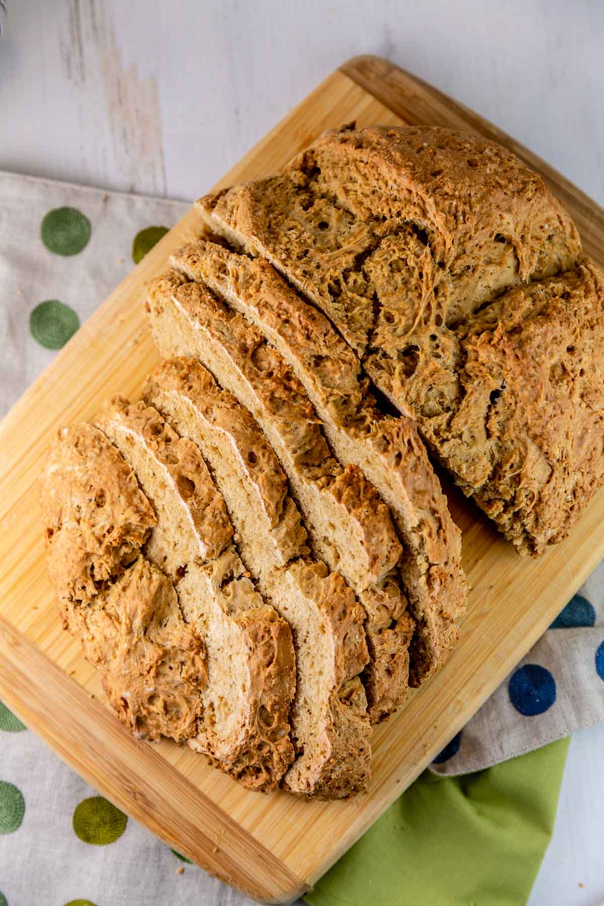 sliced loaf of irish soda bread on a wooden cutting board