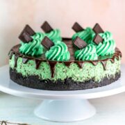 mint chocolate cheesecake with chocolate ganache and mint whipped cream swirls