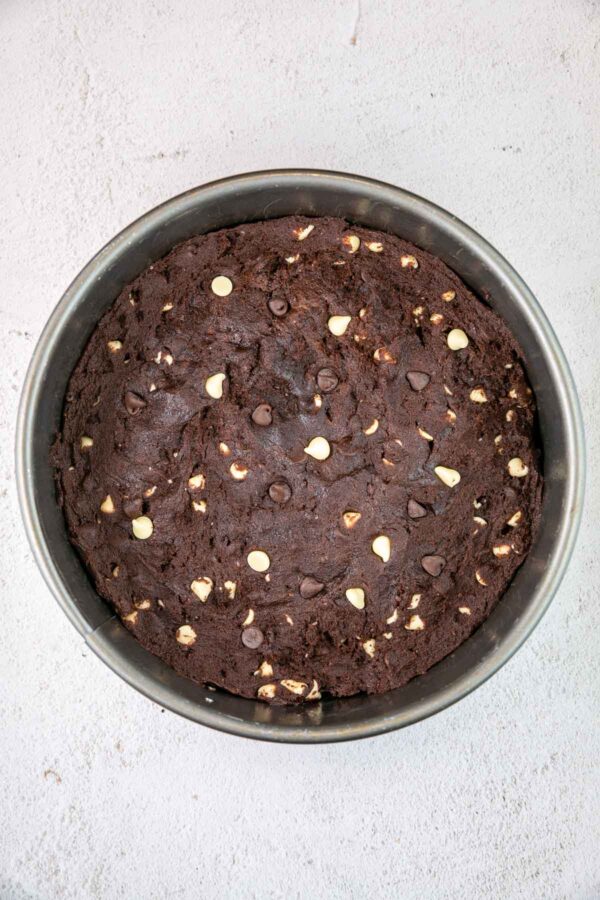 unbaked cookie cake in a springform pan