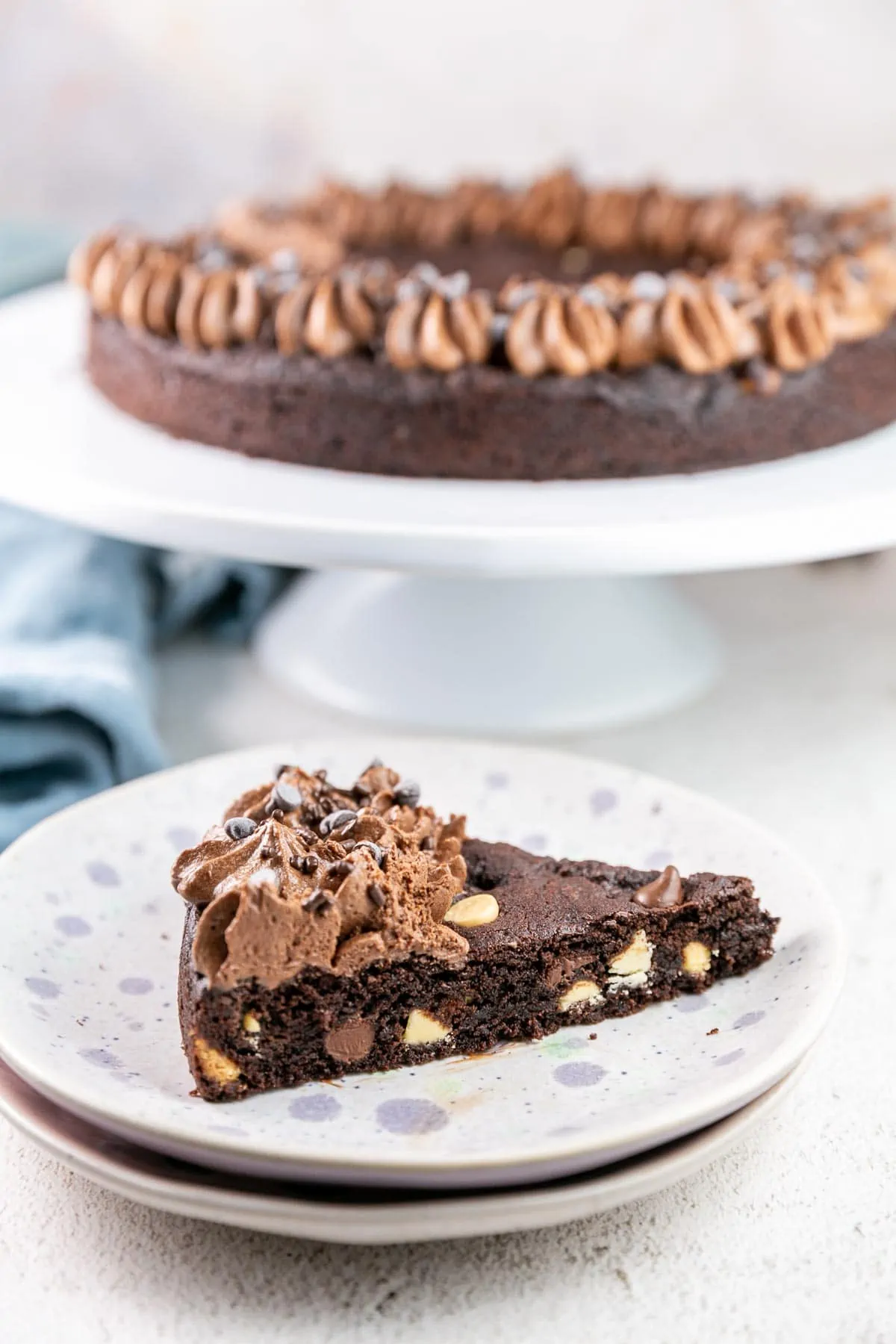 side view of a slice of cookie cake showing the thick, fudgy interior