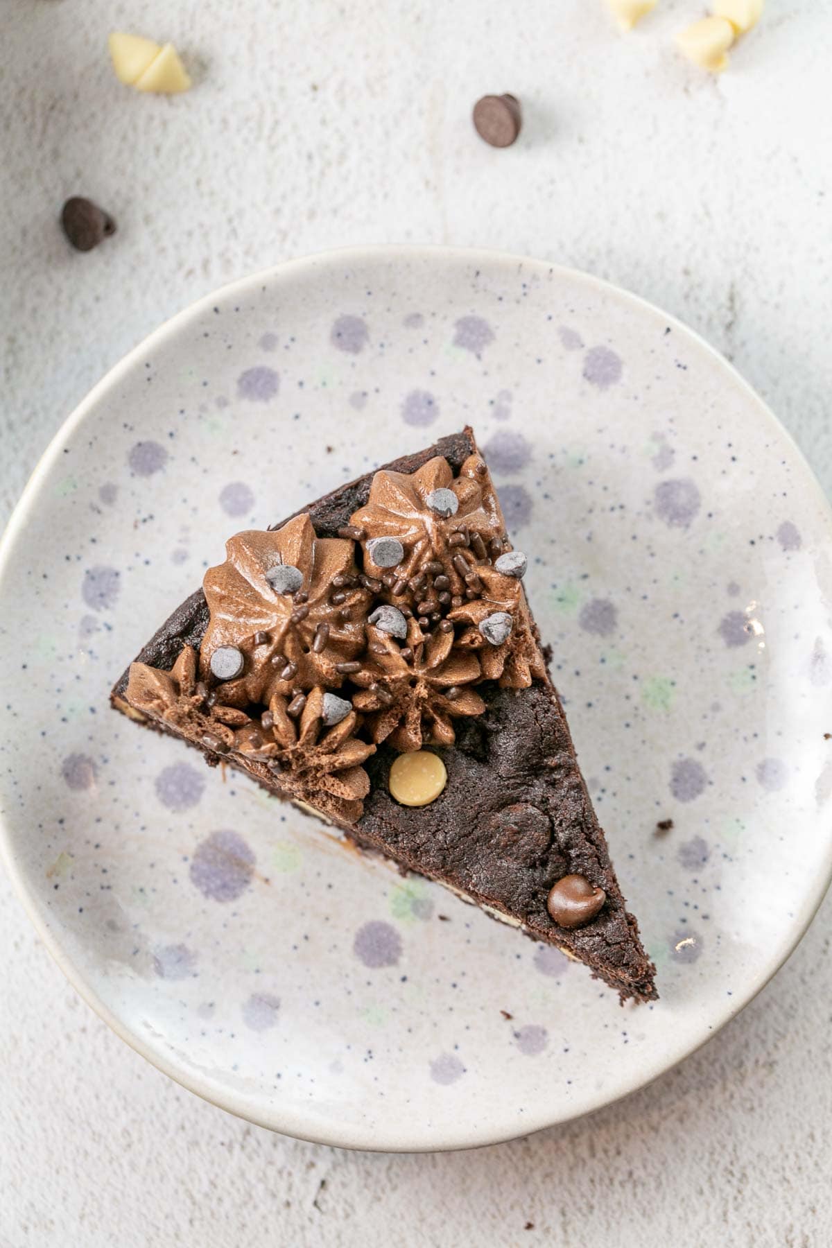 slice of cookie cake with dark and white chocolate chips visible on the surface