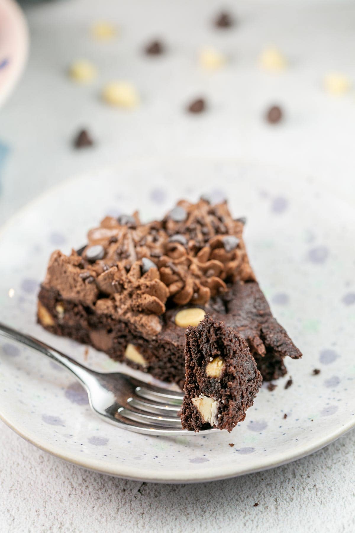 slice of dark chocolate cookie cake with one forkful of the cookie removed