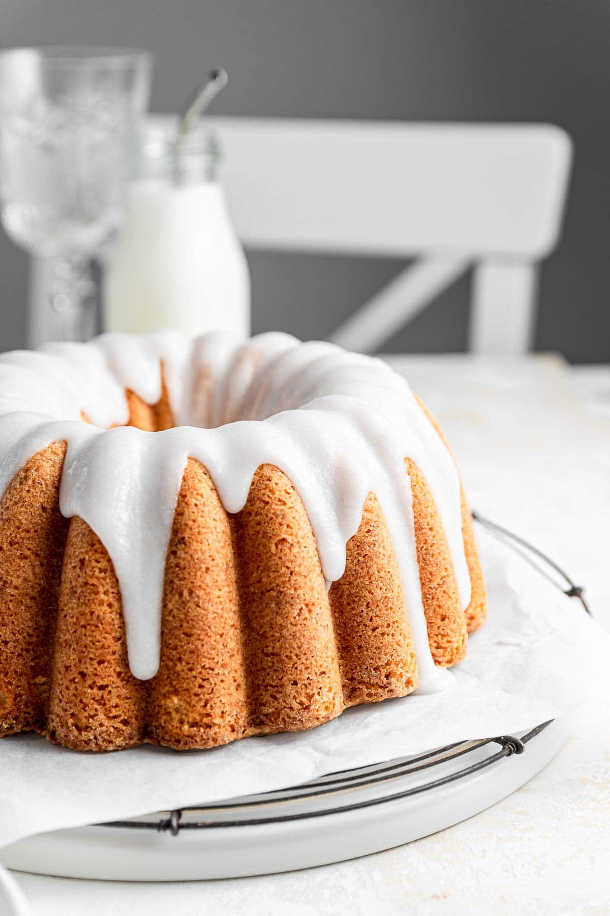 bundt cake with white coconut glaze on a kitchen table