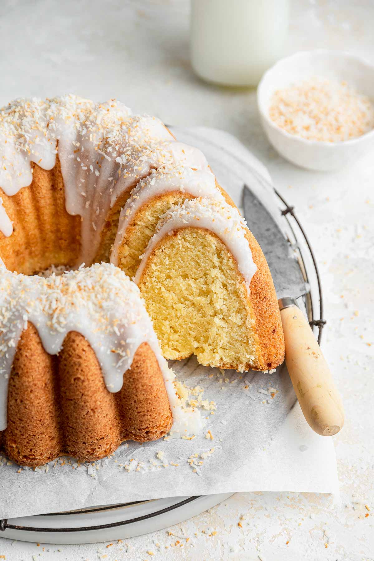 slice of bundt cake removed from a cake on a cooling rack