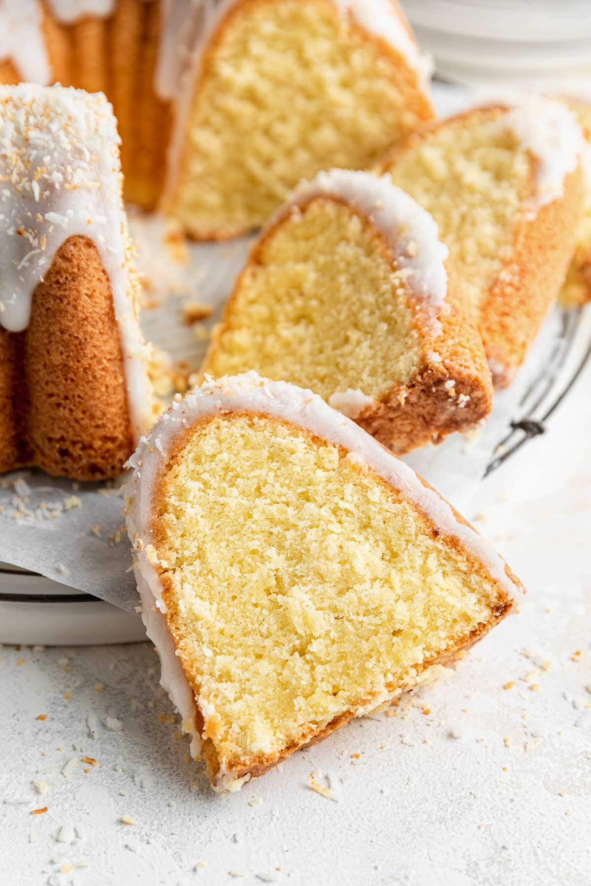close up image of one slice of coconut bundt cake highlighting the fine crumb