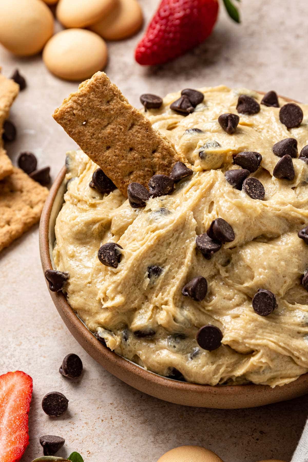 smooth and creamy dip in a bowl with a graham cracker resting in the dip