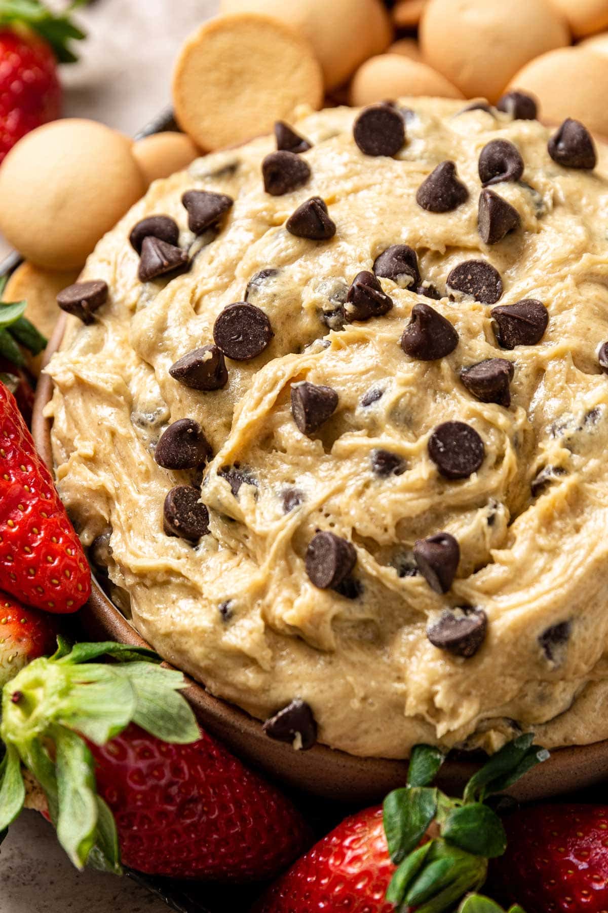 close up view of the soft swirls in a bowl of chocolate chip cookie dough dip