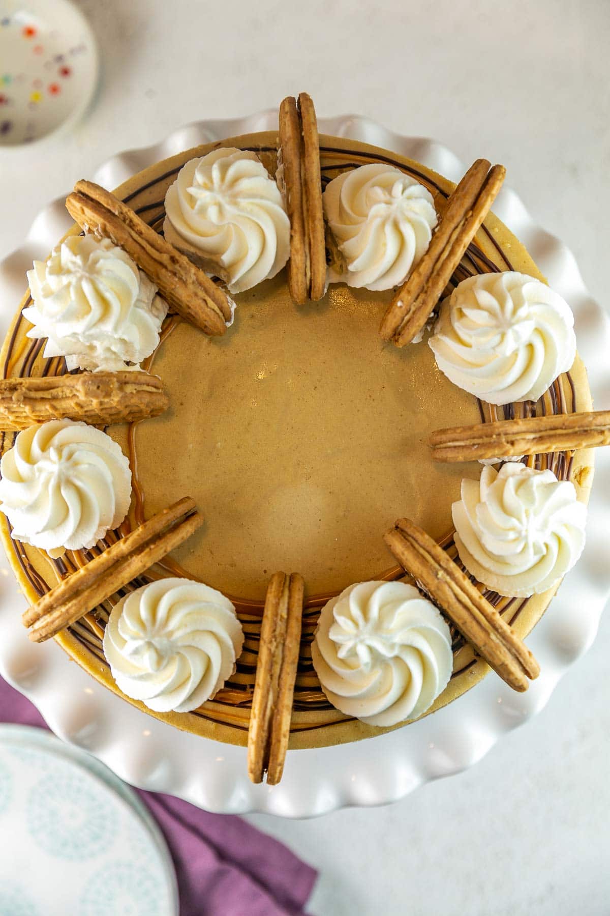 overhead view of peanut butter cheesecake decorated with whipped cream and cookies