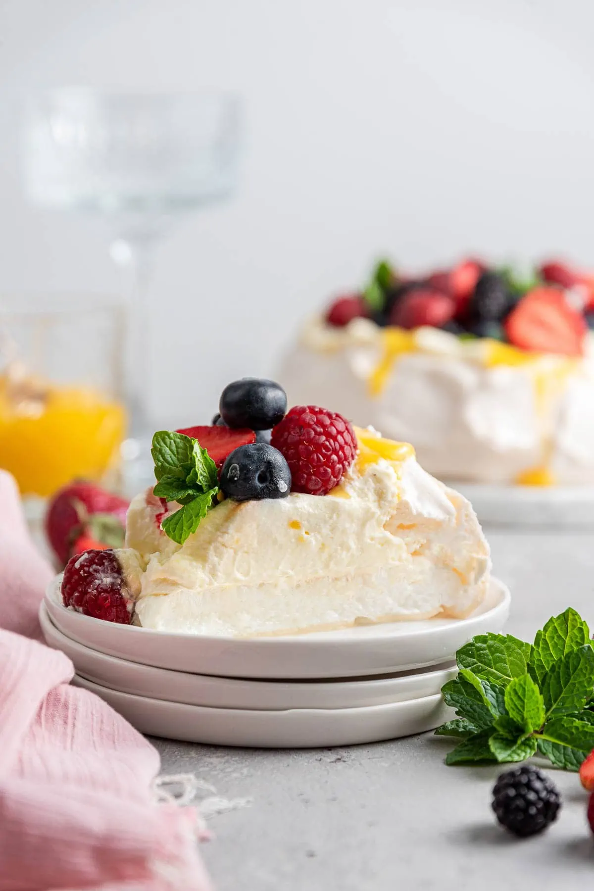 slice of pavlova on a dessert plate showing the fluffy soft interior