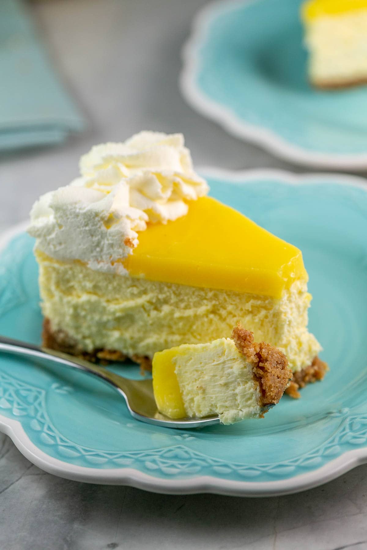 Slice of lemon cheesecake with a fork. 