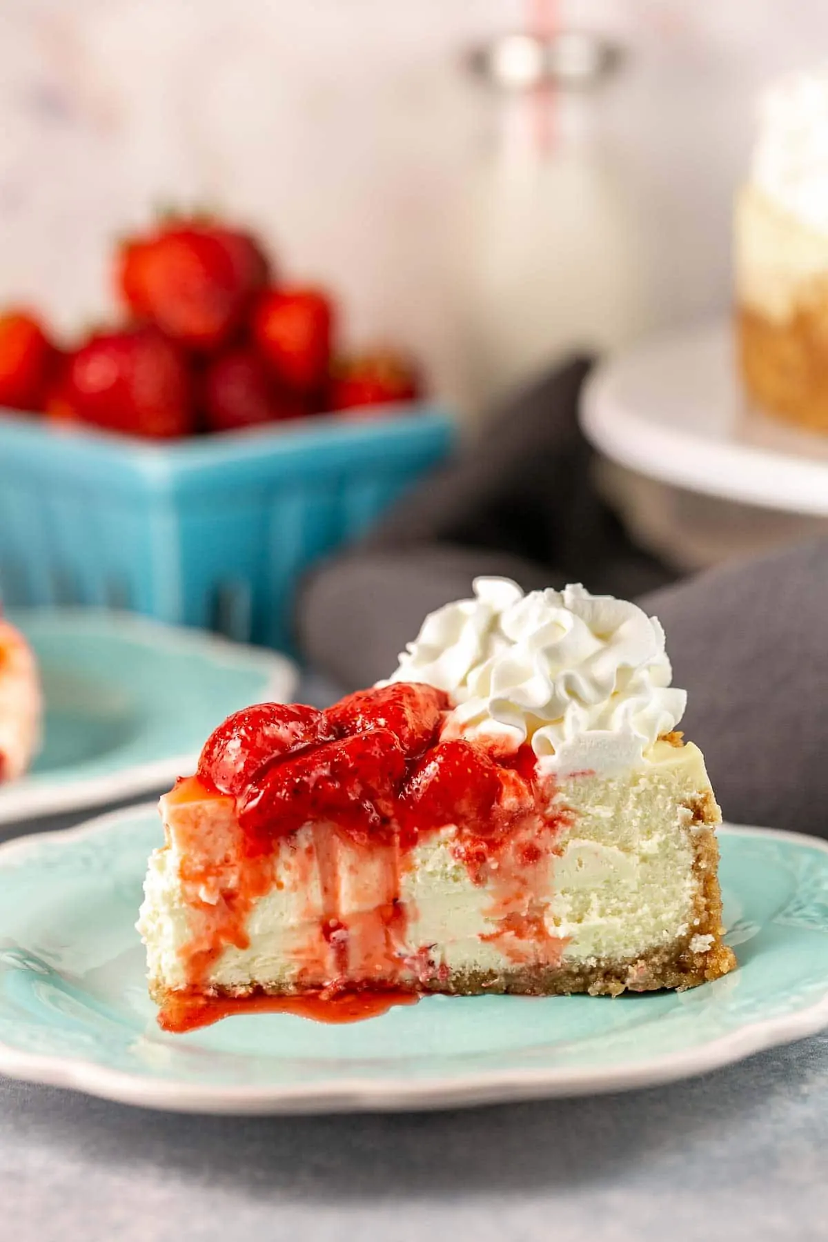 slice of cheesecake covered with fresh strawberry sauce
