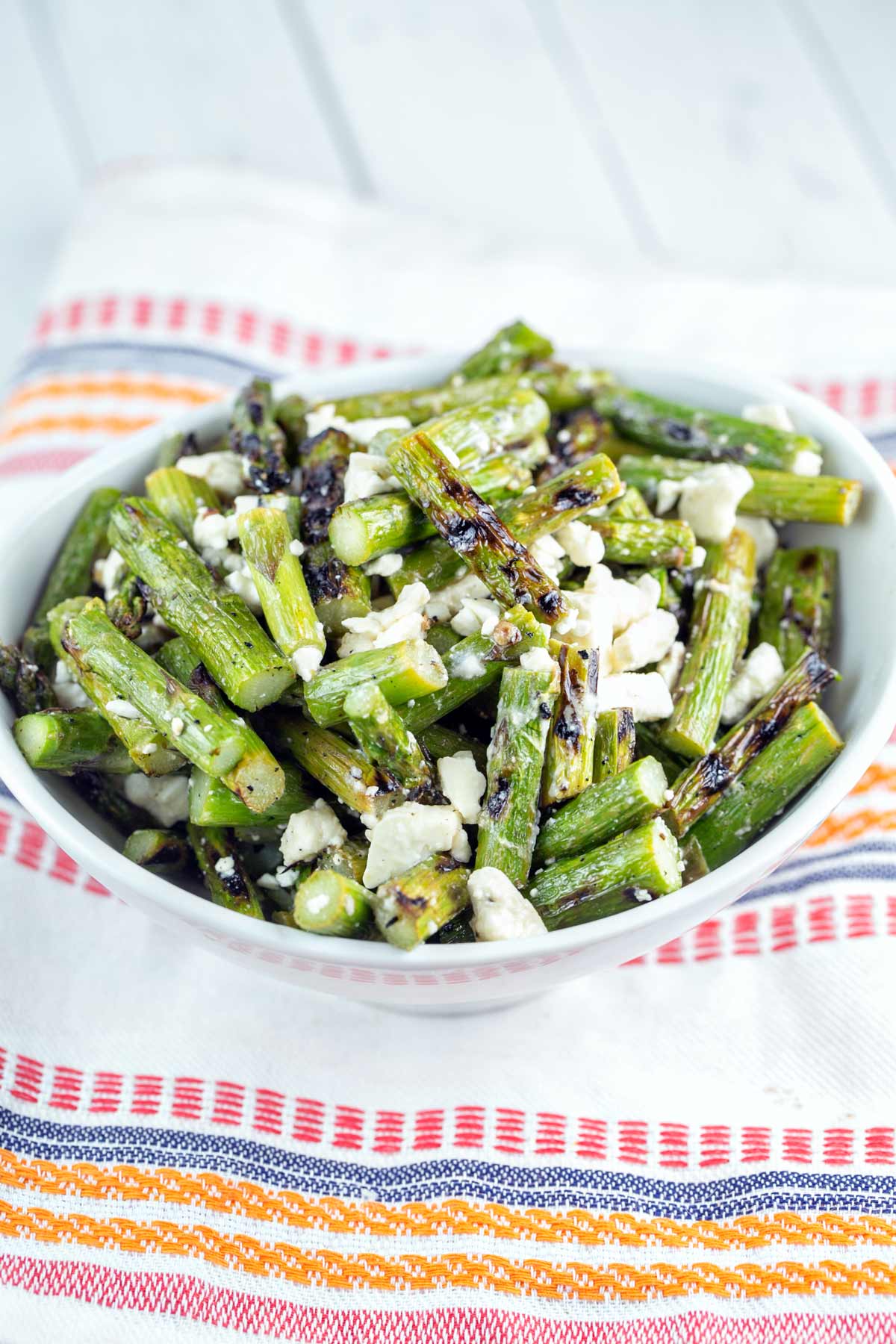 bowl filled with grilled asparagus and crumbled feta
