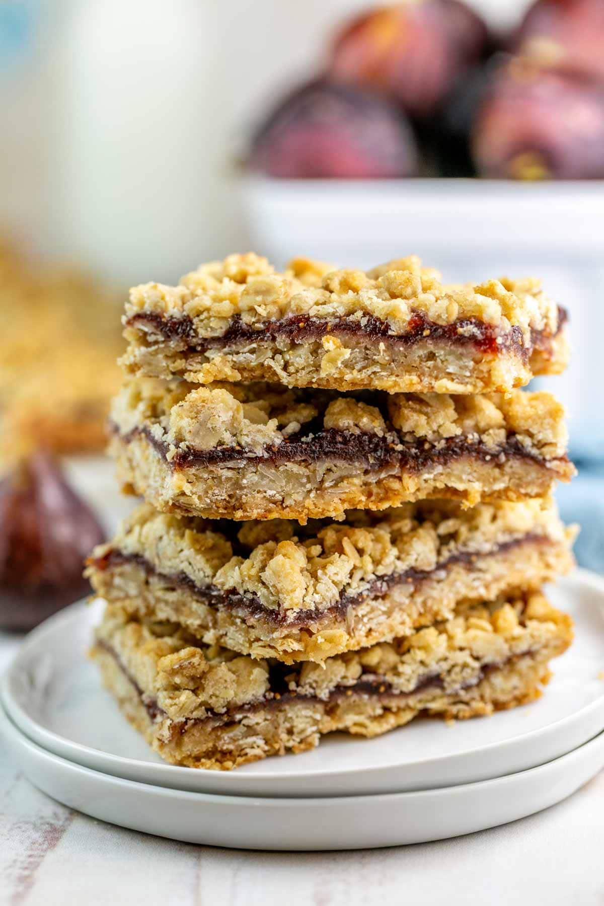 Fig bars stacked on a white plate. 