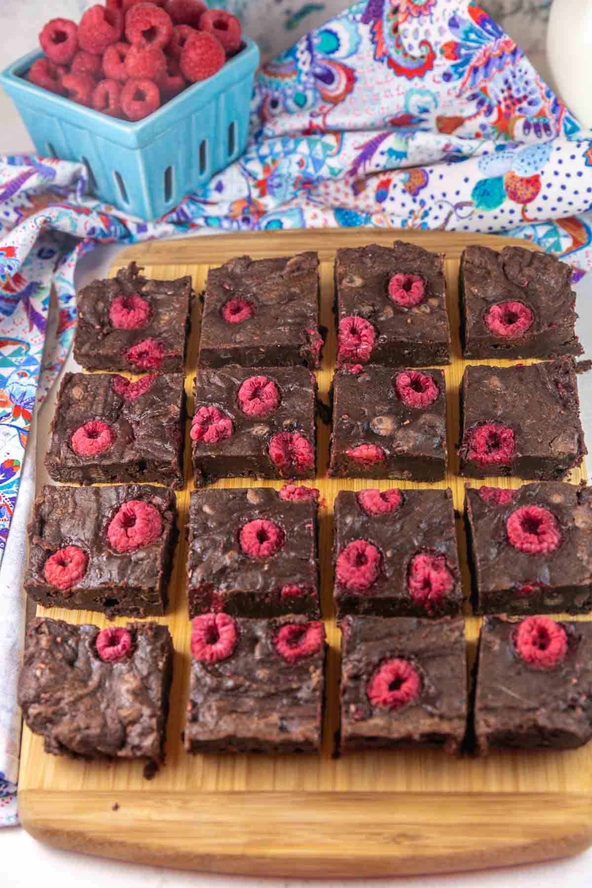 Raspberry brownies on a cutting board.