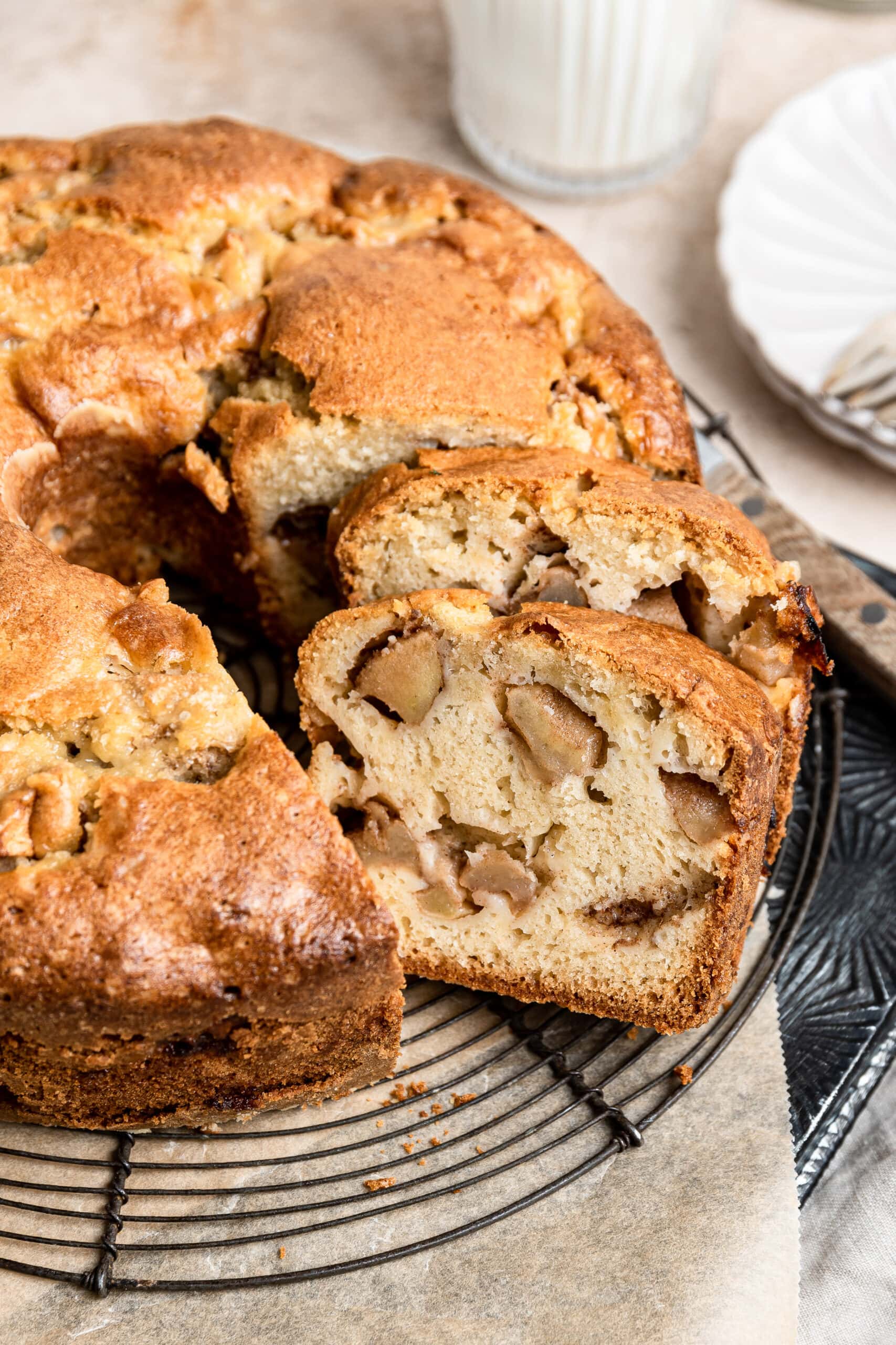 apple cake baked in a tube pan with two slices cut out