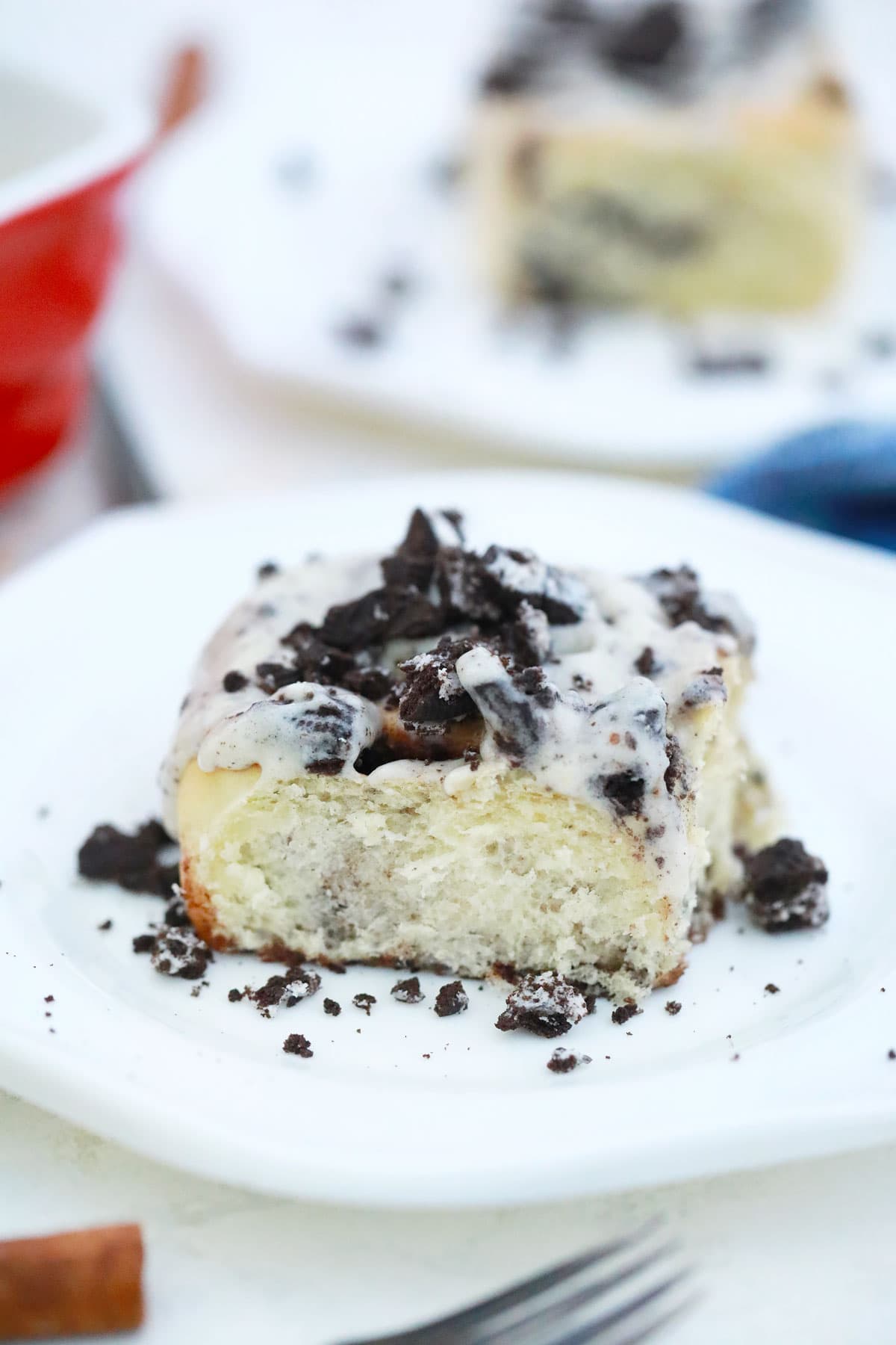 cinnamon roll covered with oreos and cream cheese frosting