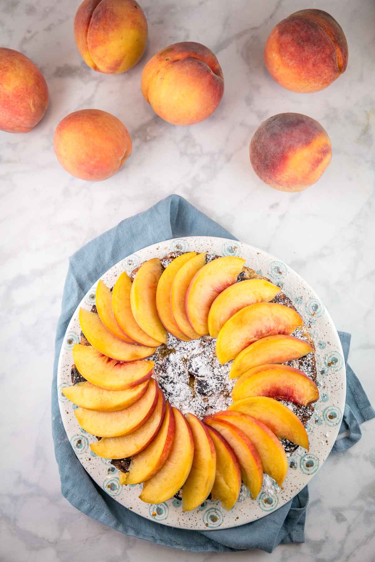 french toast covered with a ring of freshly sliced peaches