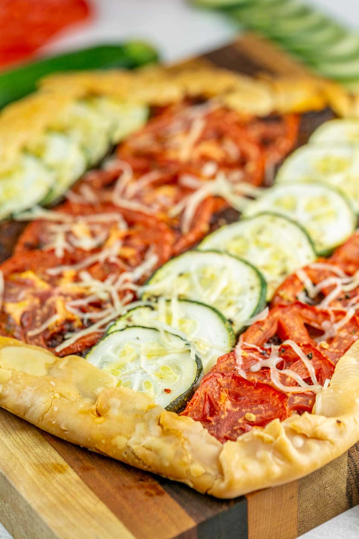 straight rows of tomato and zucchini slices in a galette crust