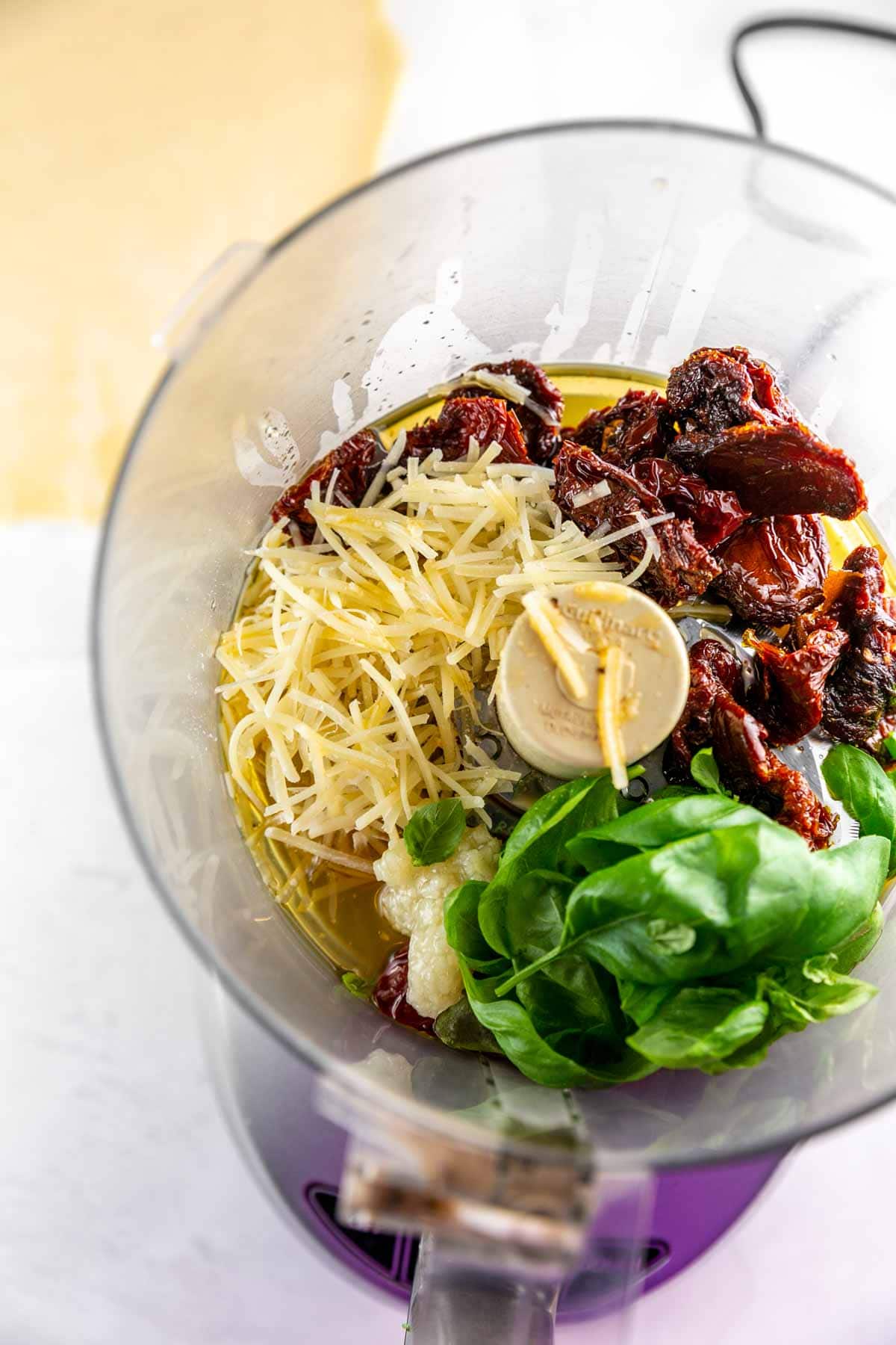 ingredients for homemade sundried tomato pesto in a food processor