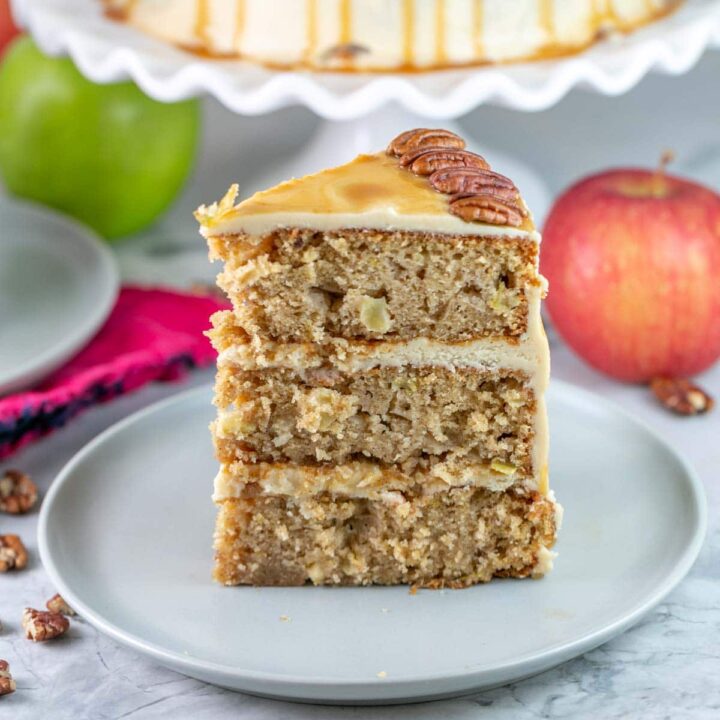 one slice of a three layer apple cake covered with caramel frosting