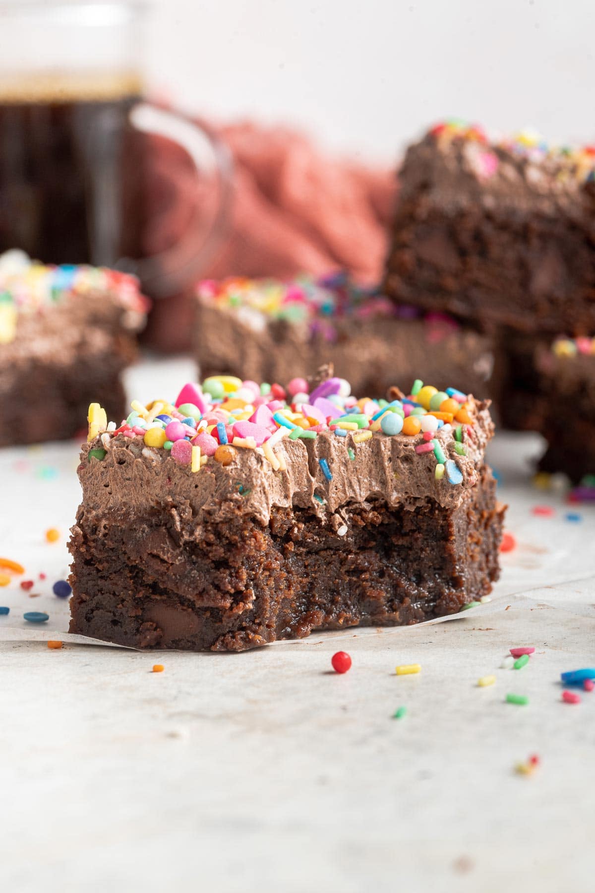 one brownie covered in frosting with a bite taken out of it