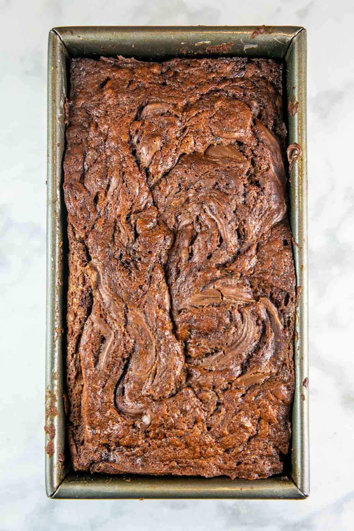 Top view of baked banana bread in a loaf pan.