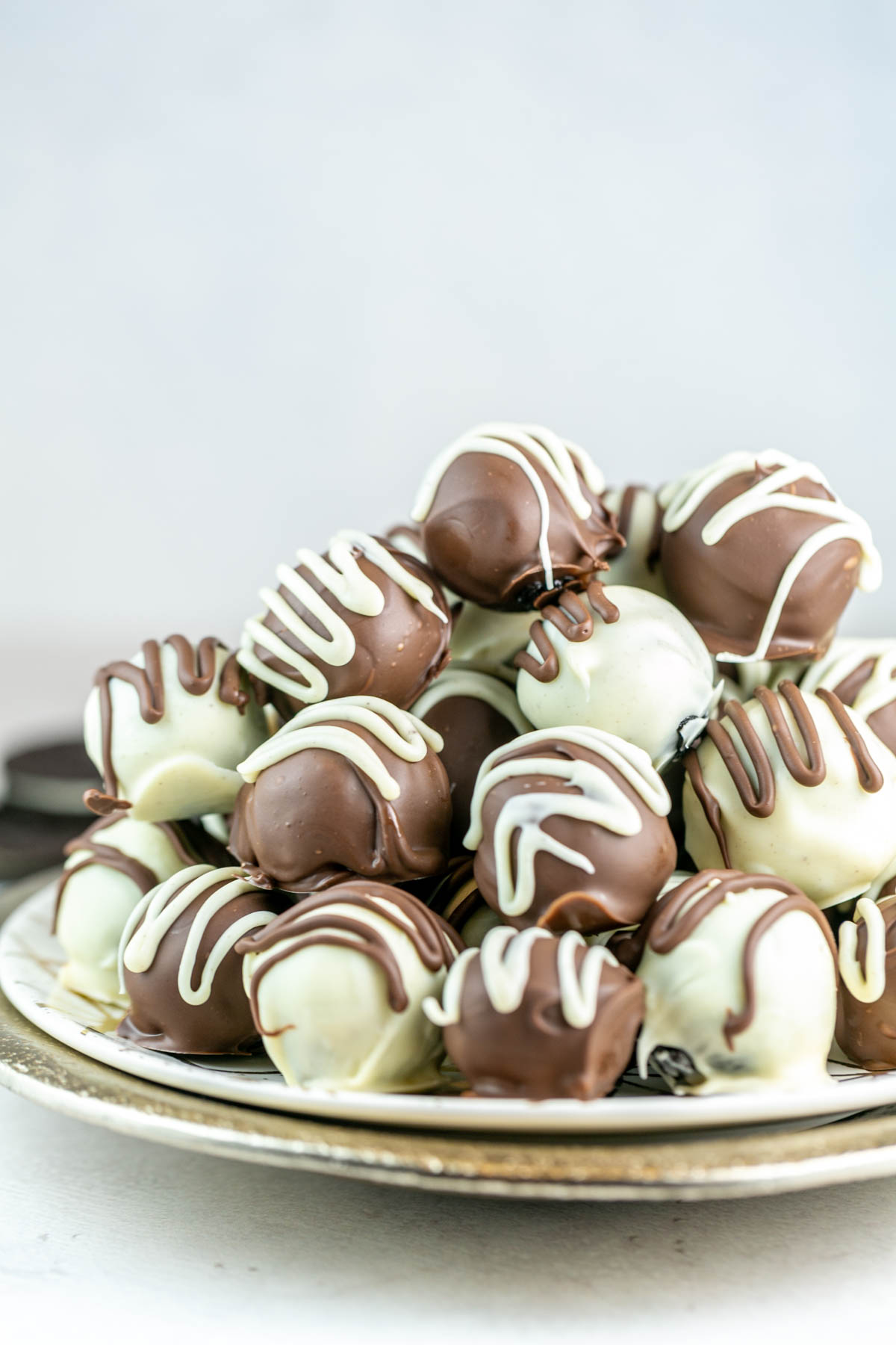 oreo balls piled on a decorative gold plate