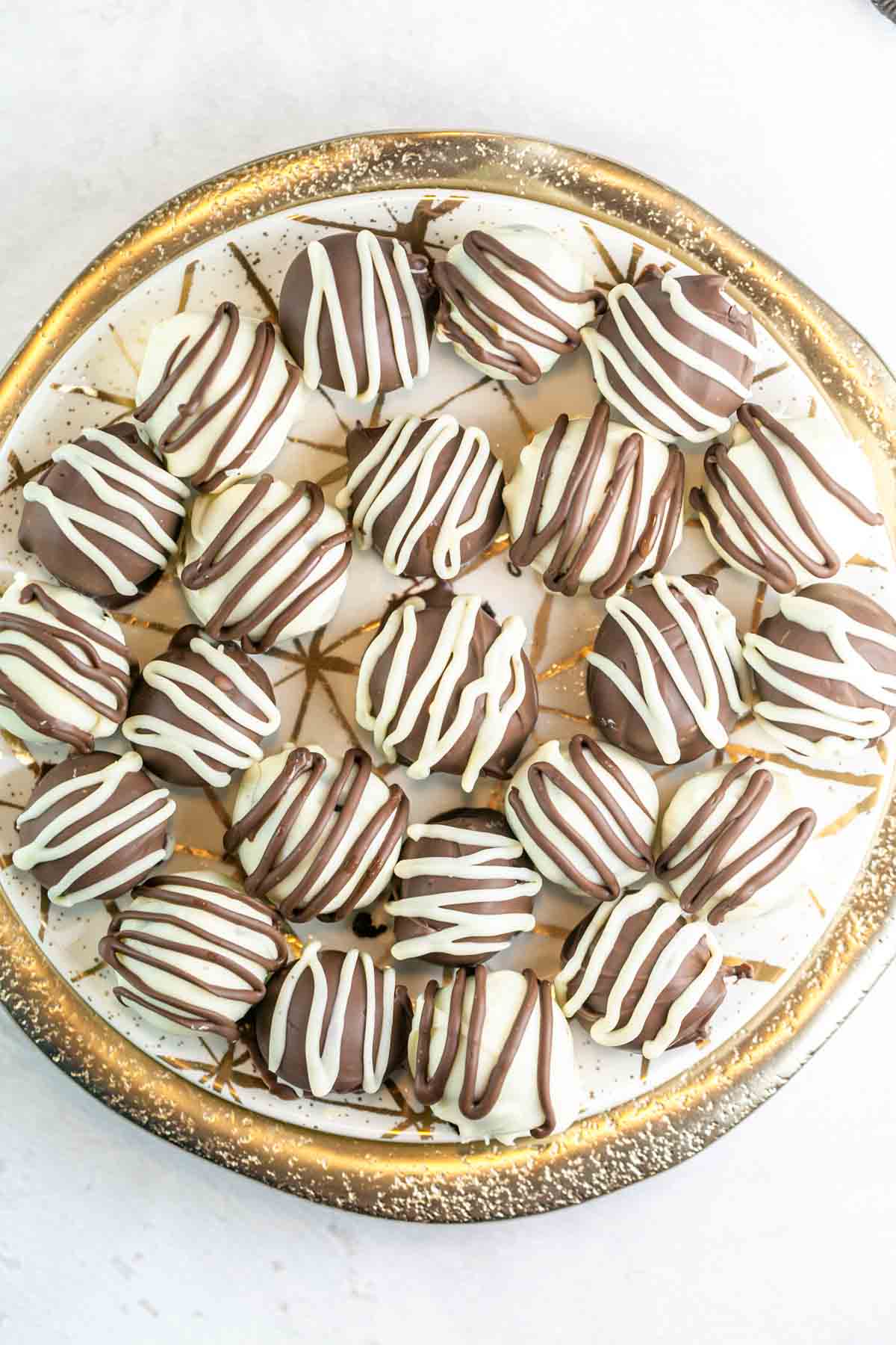 decorated truffles on a fancy gold plate