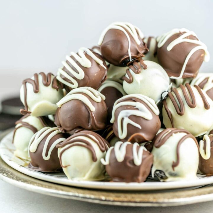 pile of oreo truffles dipped in dark and white chocolate