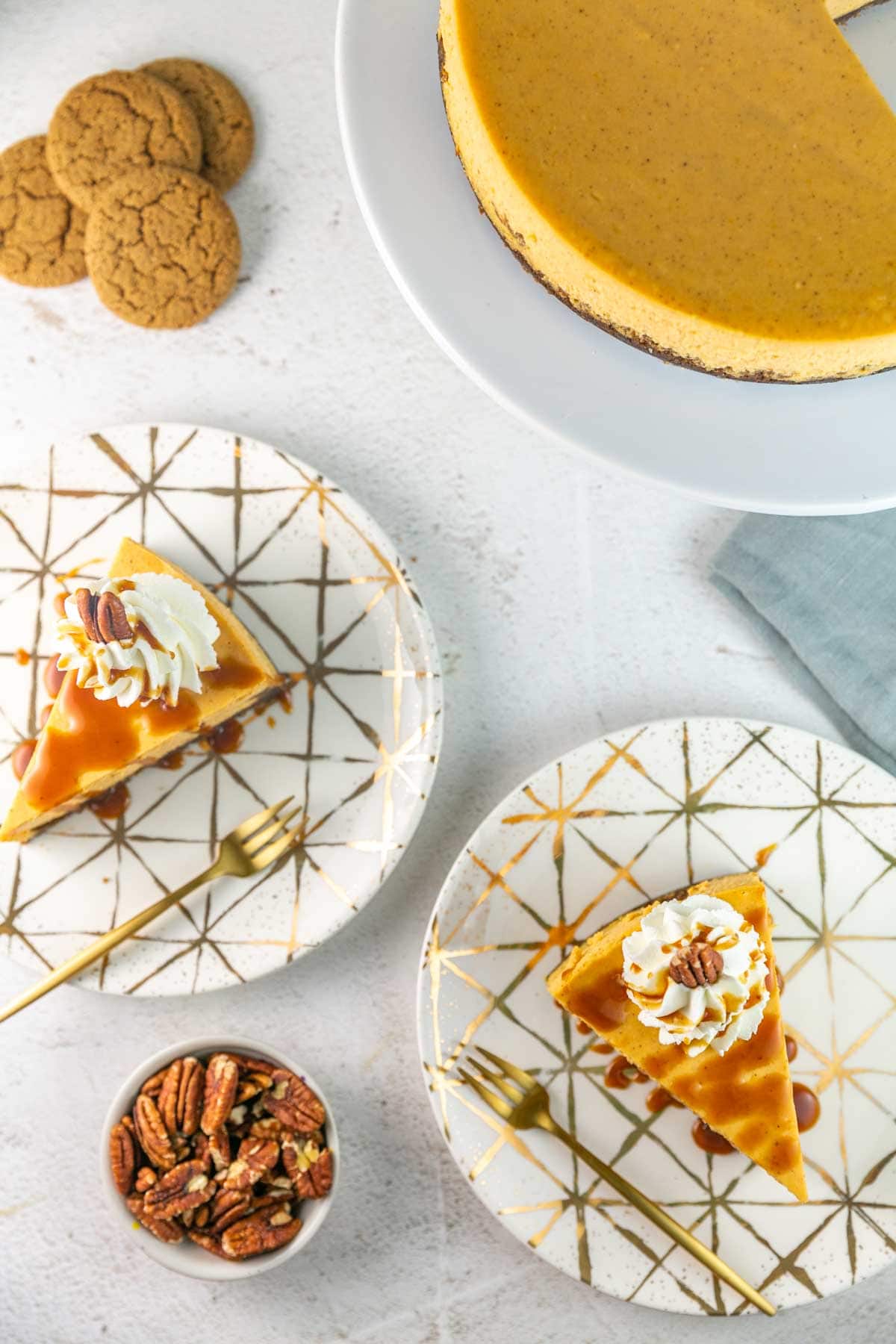 overhead view of two slices of sweet potato cheesecake on gold plates.