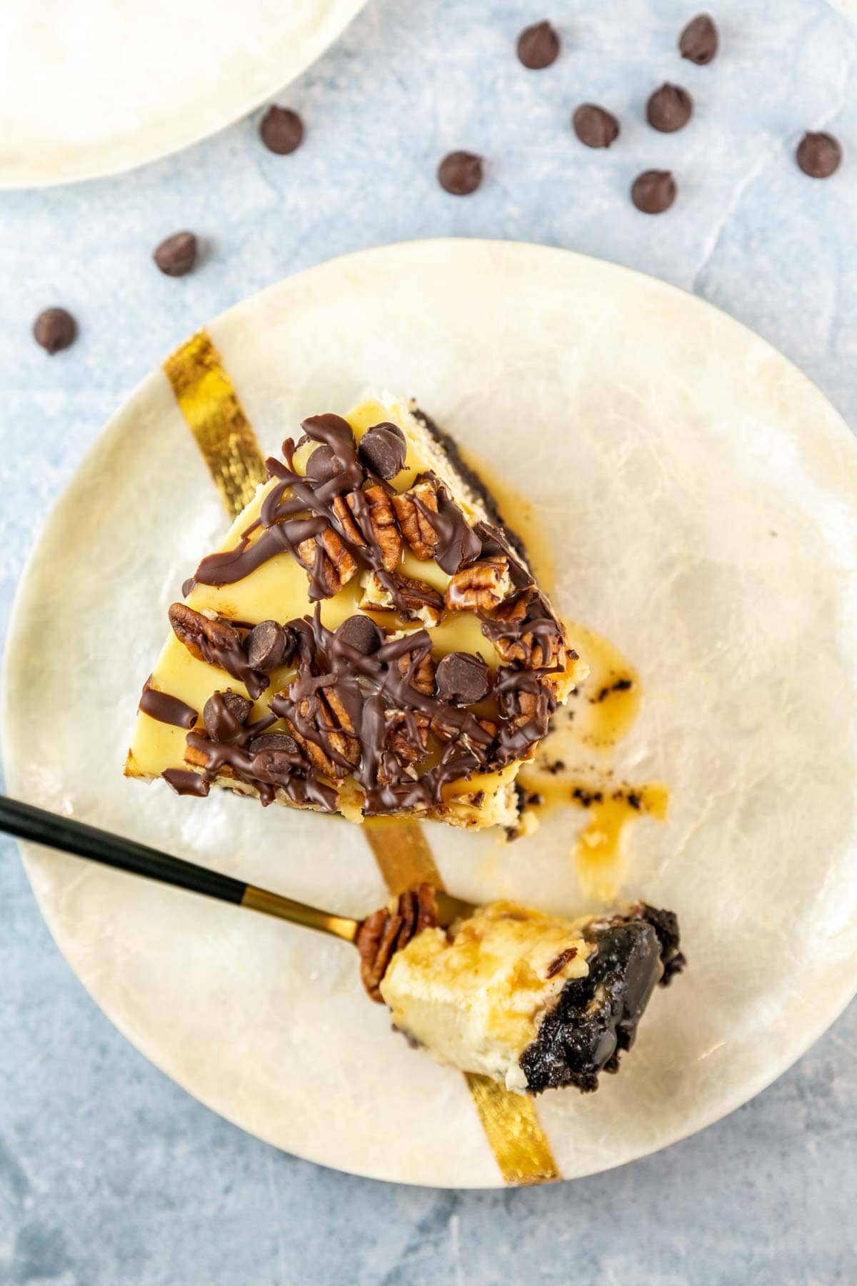 Birds eye view of a slice of cheesecake on a white plate with a fork.