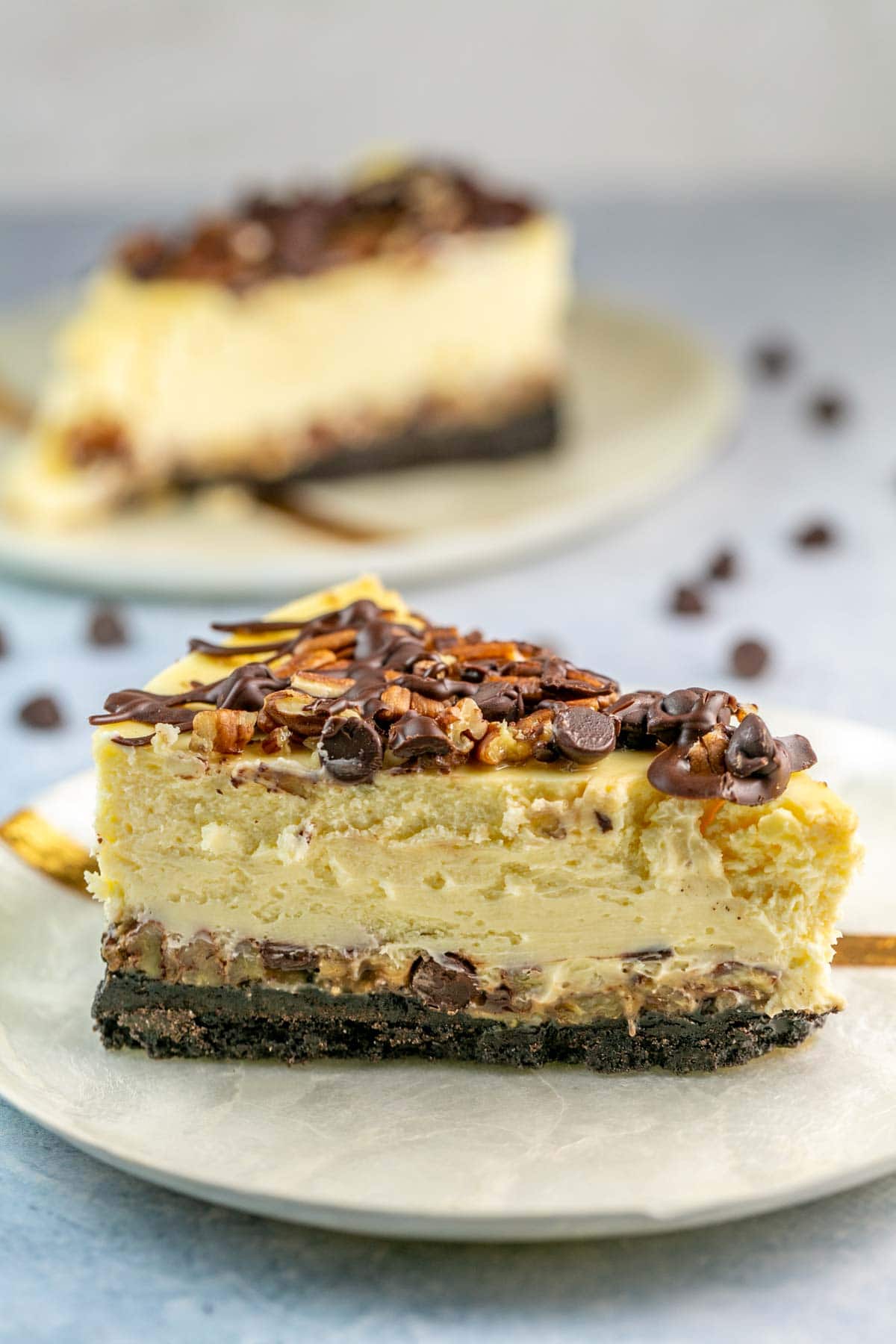 Slice of turtle cheesecake on a white plate.