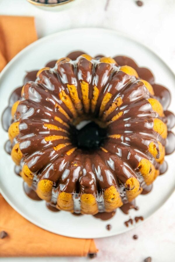 overhead view of a bundt cake with chocolate ganache dripping down the sides
