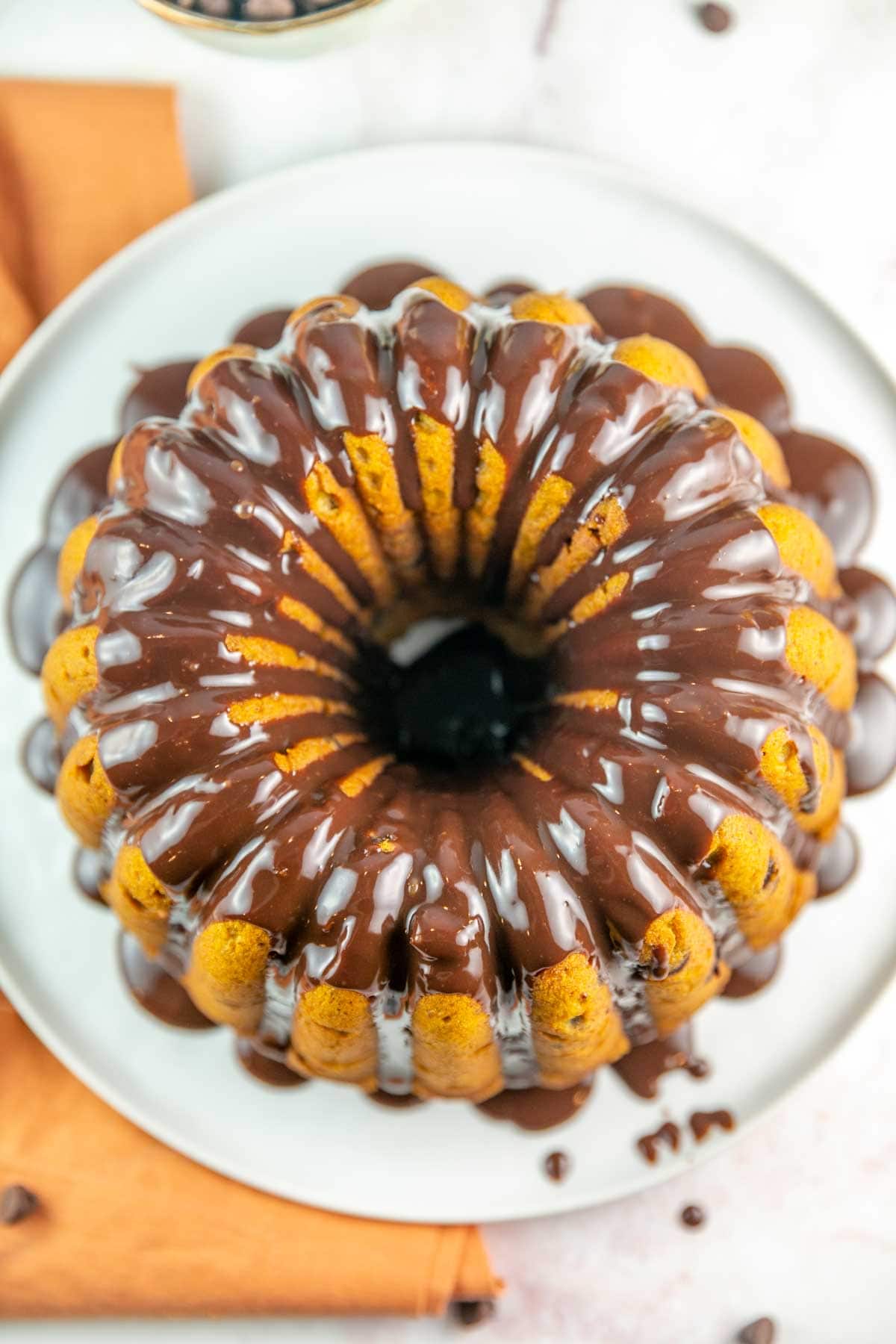 overhead view of a bundt cake with chocolate ganache dripping down the sides