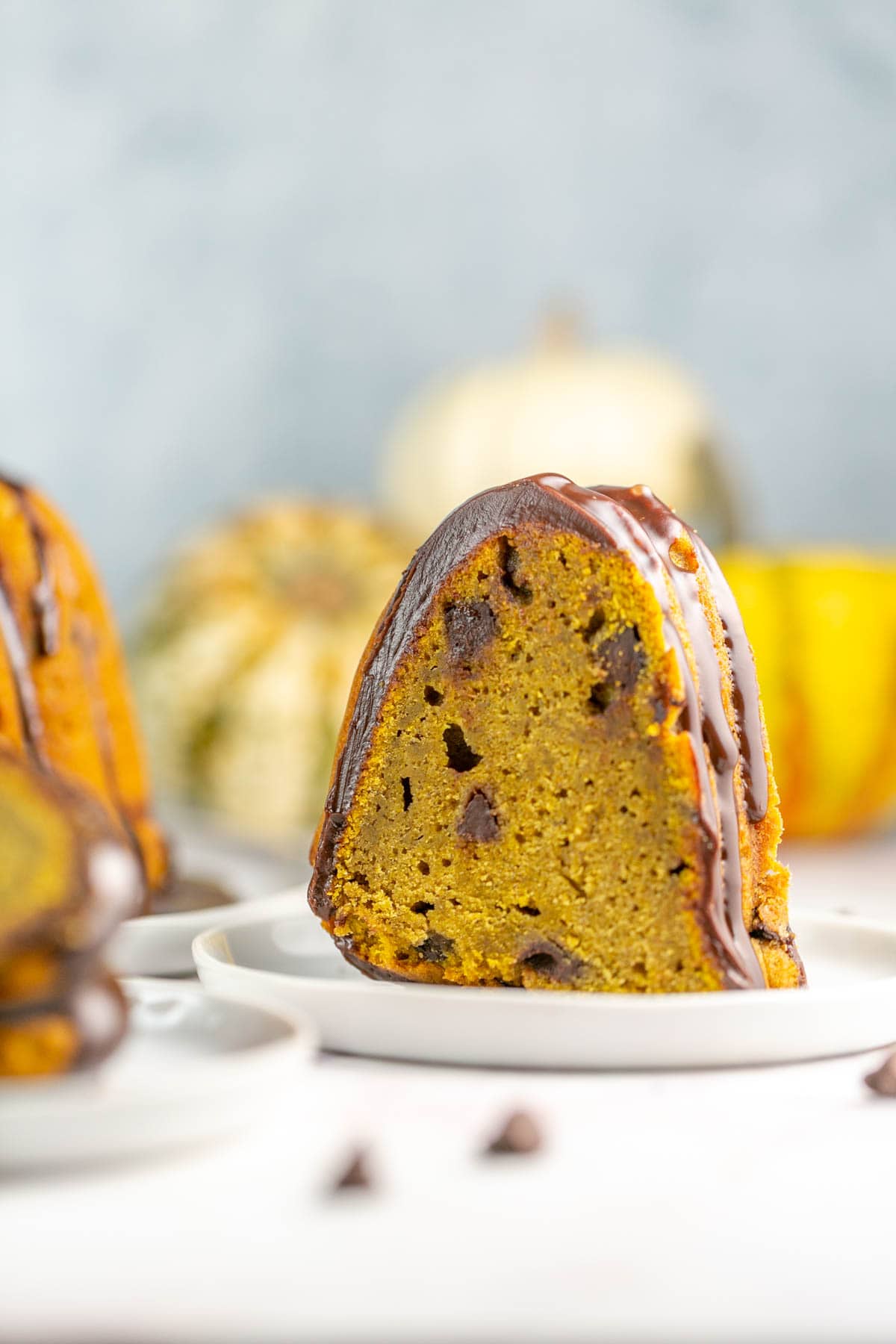 tall slice of pumpkin bundt cake filled with chocolate chips