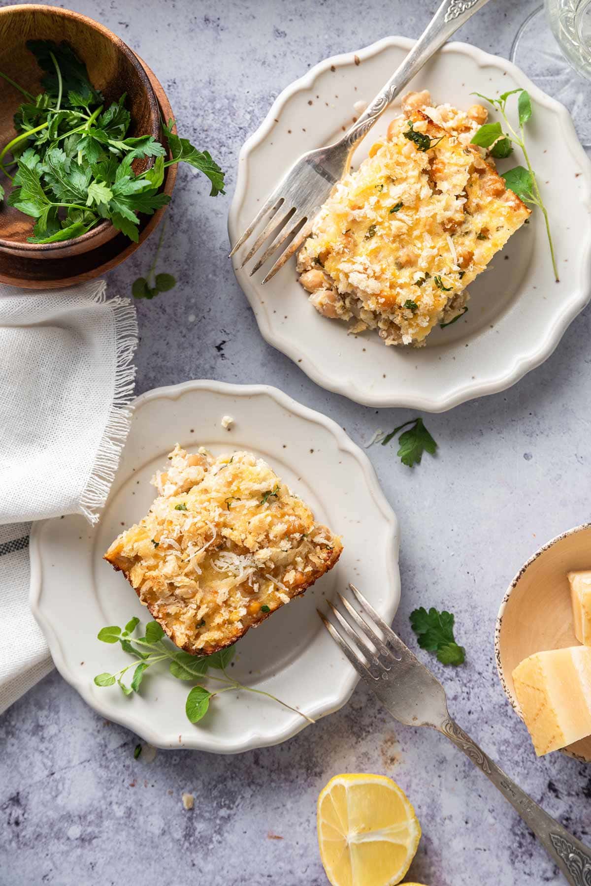 cut squares of vegetarian casserole on small white plates.