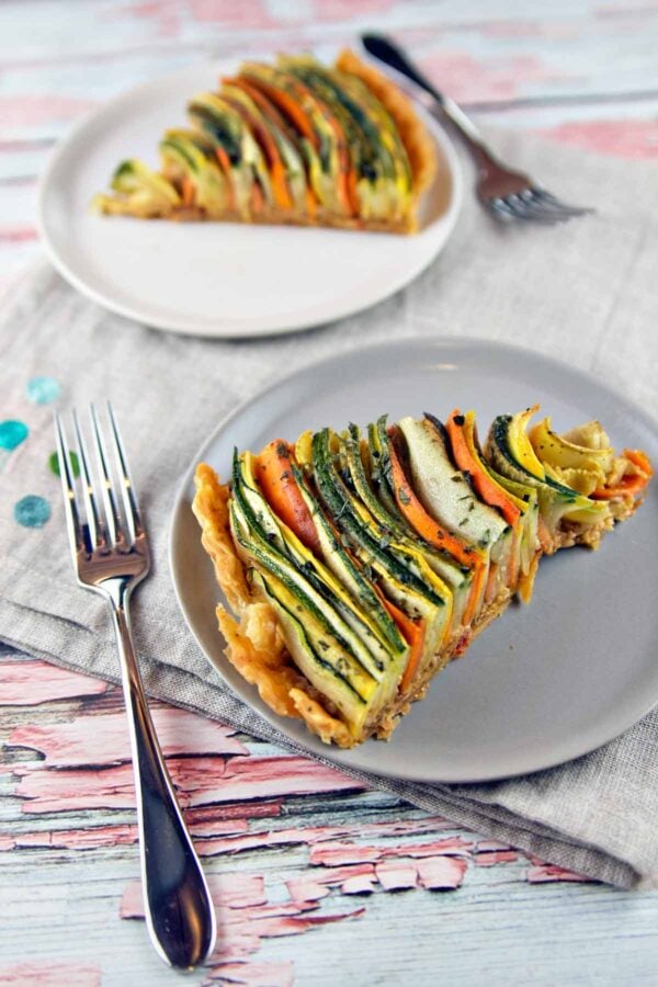two slices of a zucchini, squash, and carrot vegetable tart