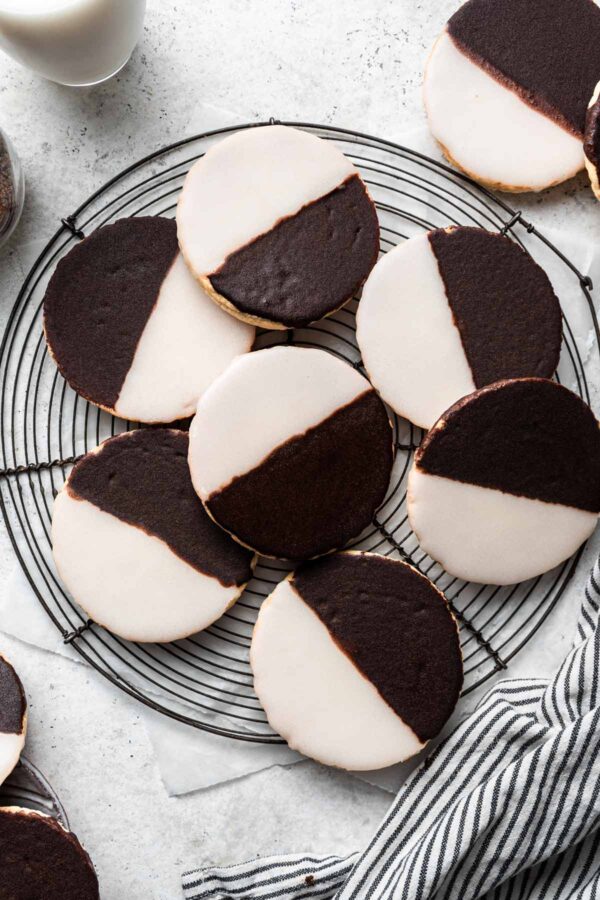 pile of black and white cookies on a round cooking rack