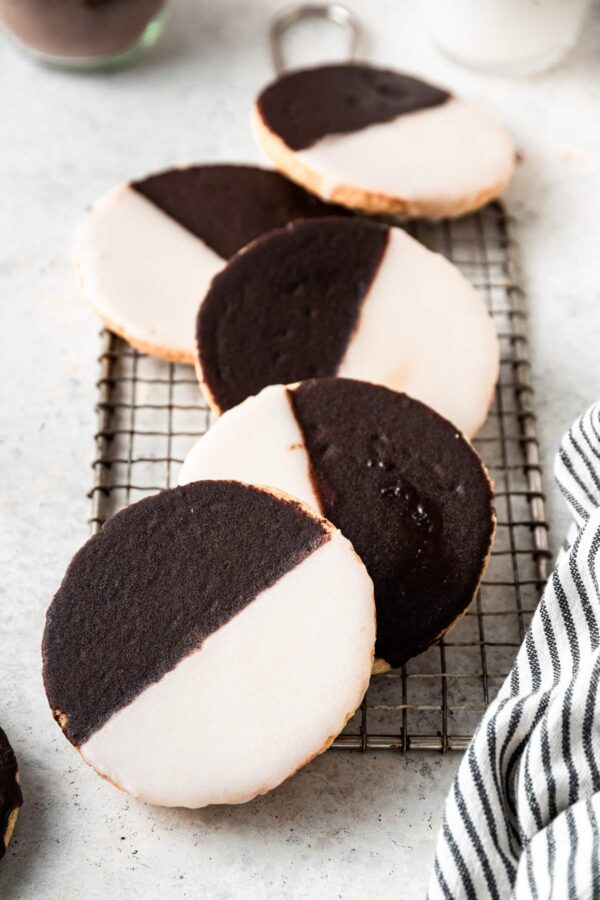 5 soft and pillowy black and white cookies lined up in a row