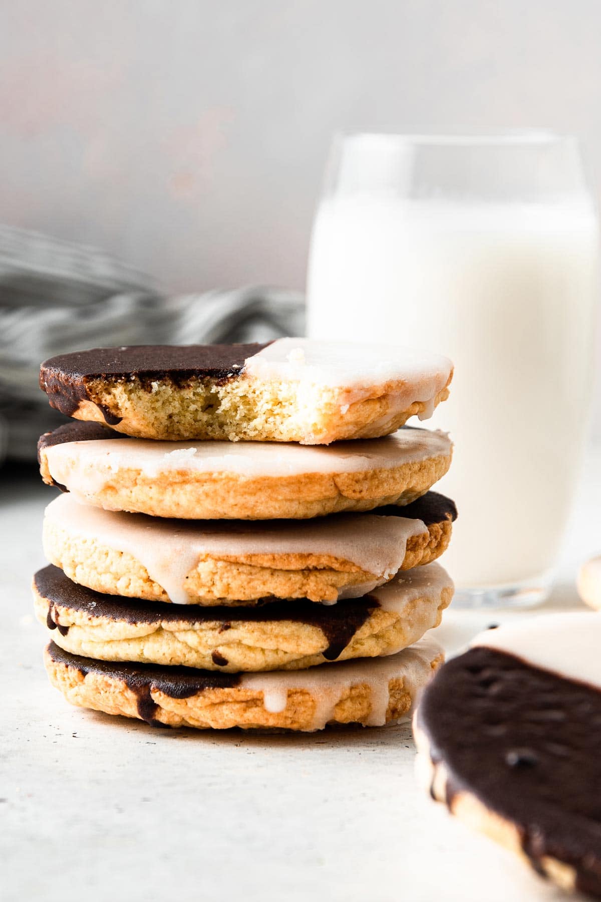 stack of black and white cookies with a bite taken out of one cookie