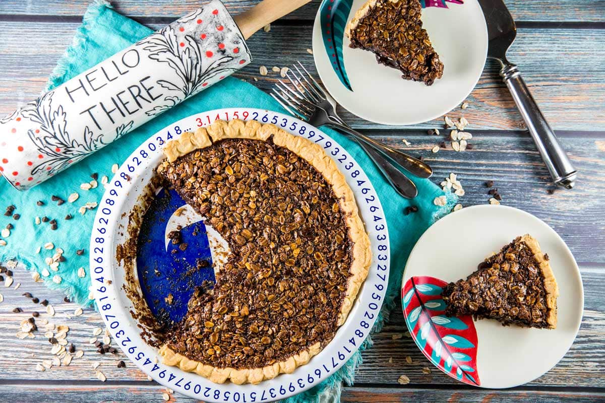 molasses oatmeal pie with two slices on dessert plates and rolling pin in the background