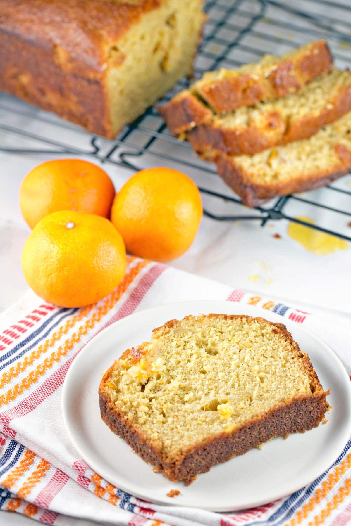 side view of a slice of clementine vanilla quick bread on a dessert plate