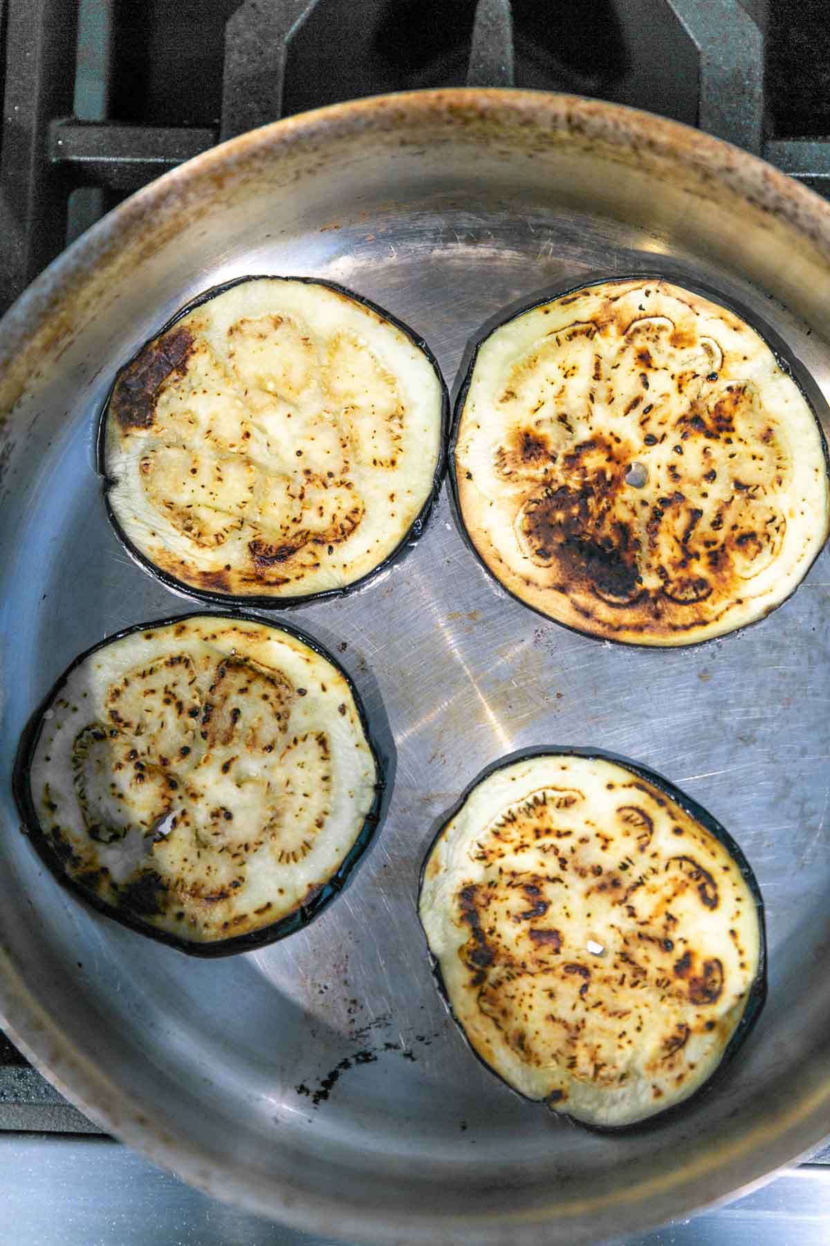 pan frying eggplant in a large skillet