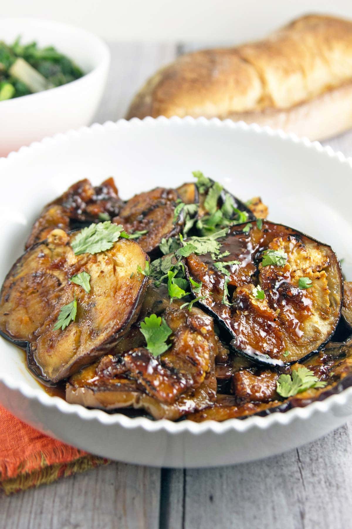 sweet and spicy honey glazed moroccan eggplant in a white serving bowl