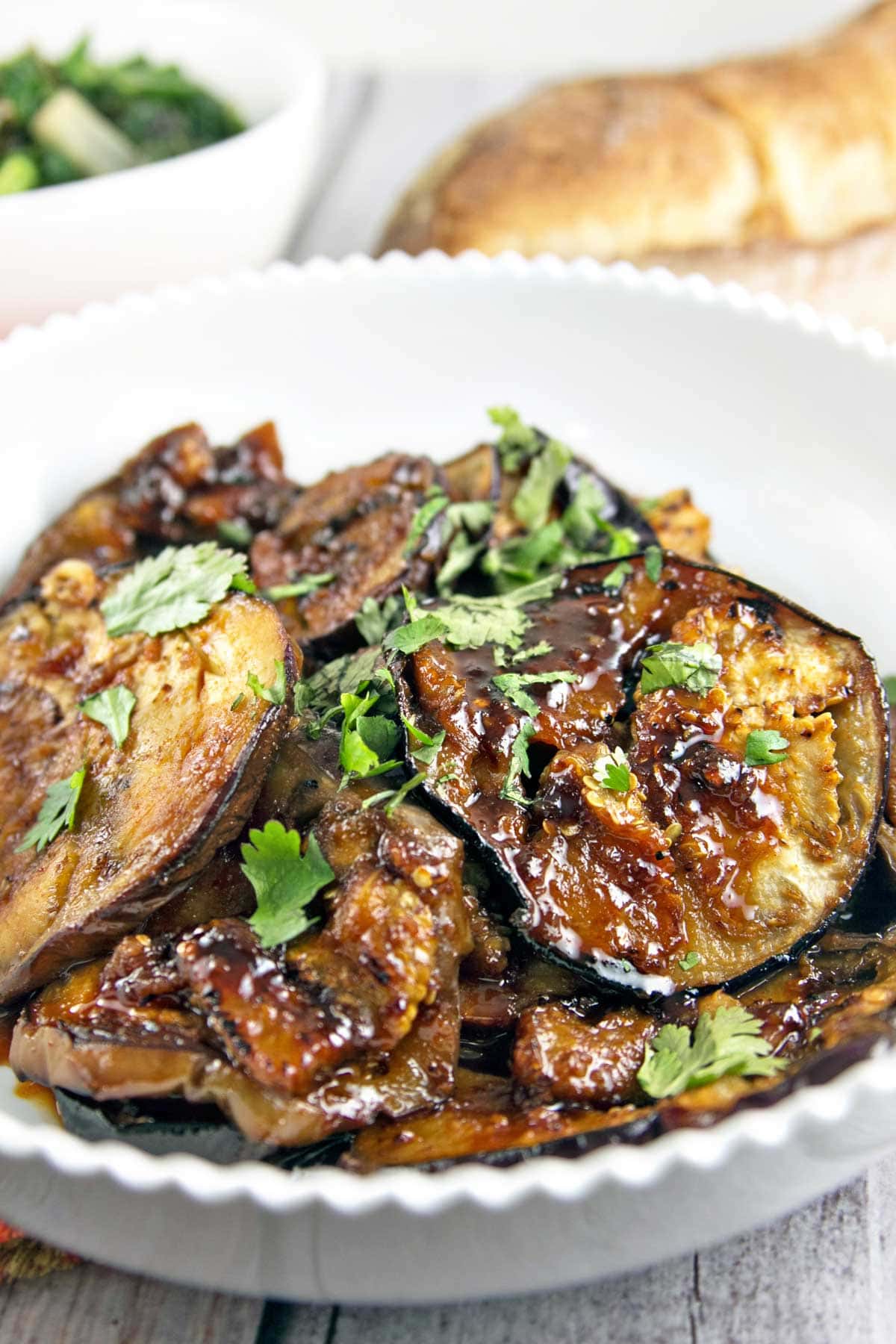 close up view of harissa and honey glazed moroccan eggplant with a sprinkle of cilantro