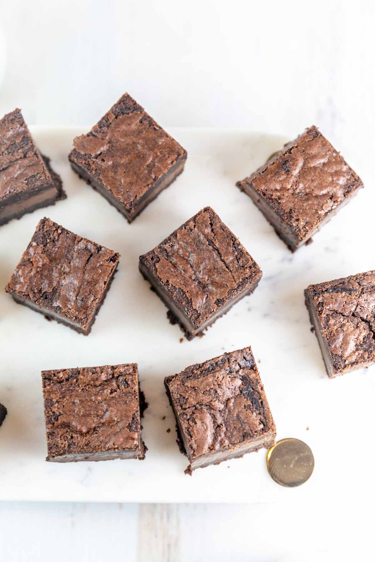 squares of nutella brownies cut and arranged on a marble serving board