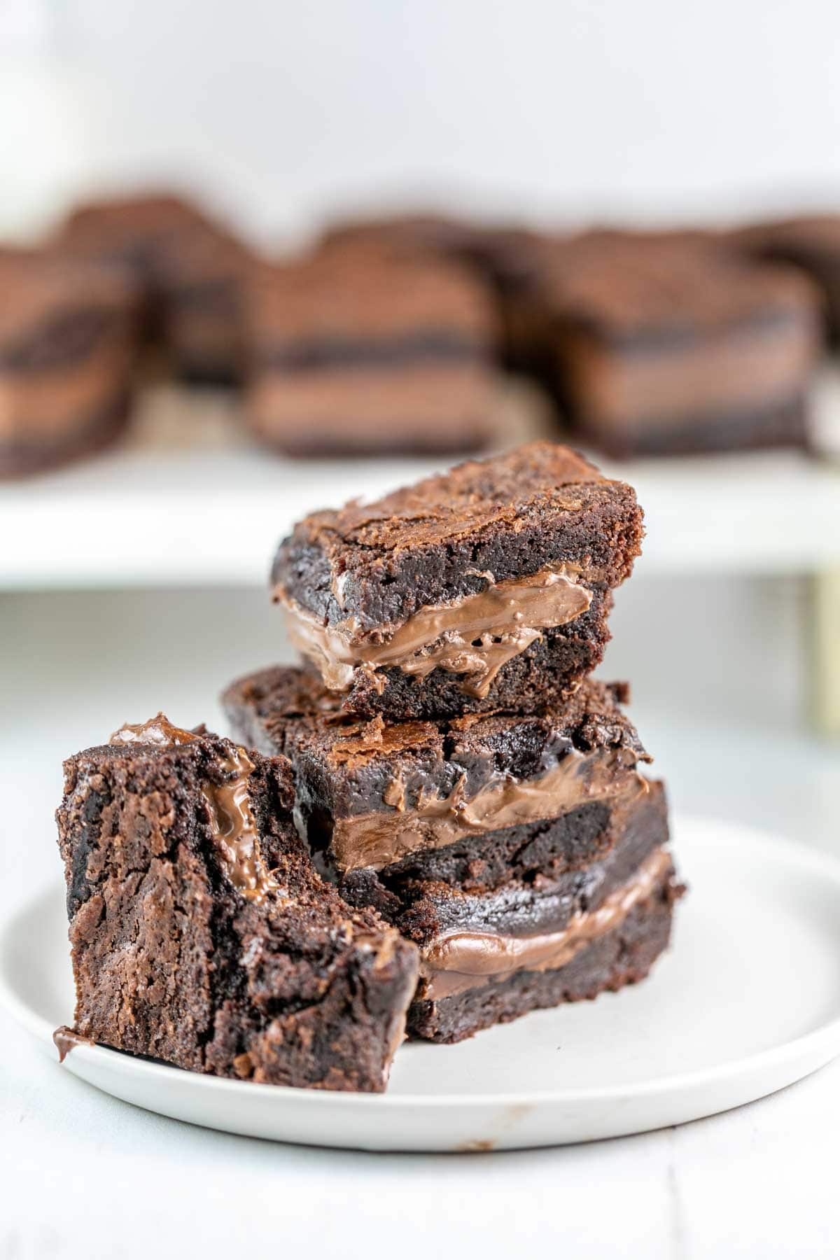 brownies on a plate with a bite taken out of one brownie