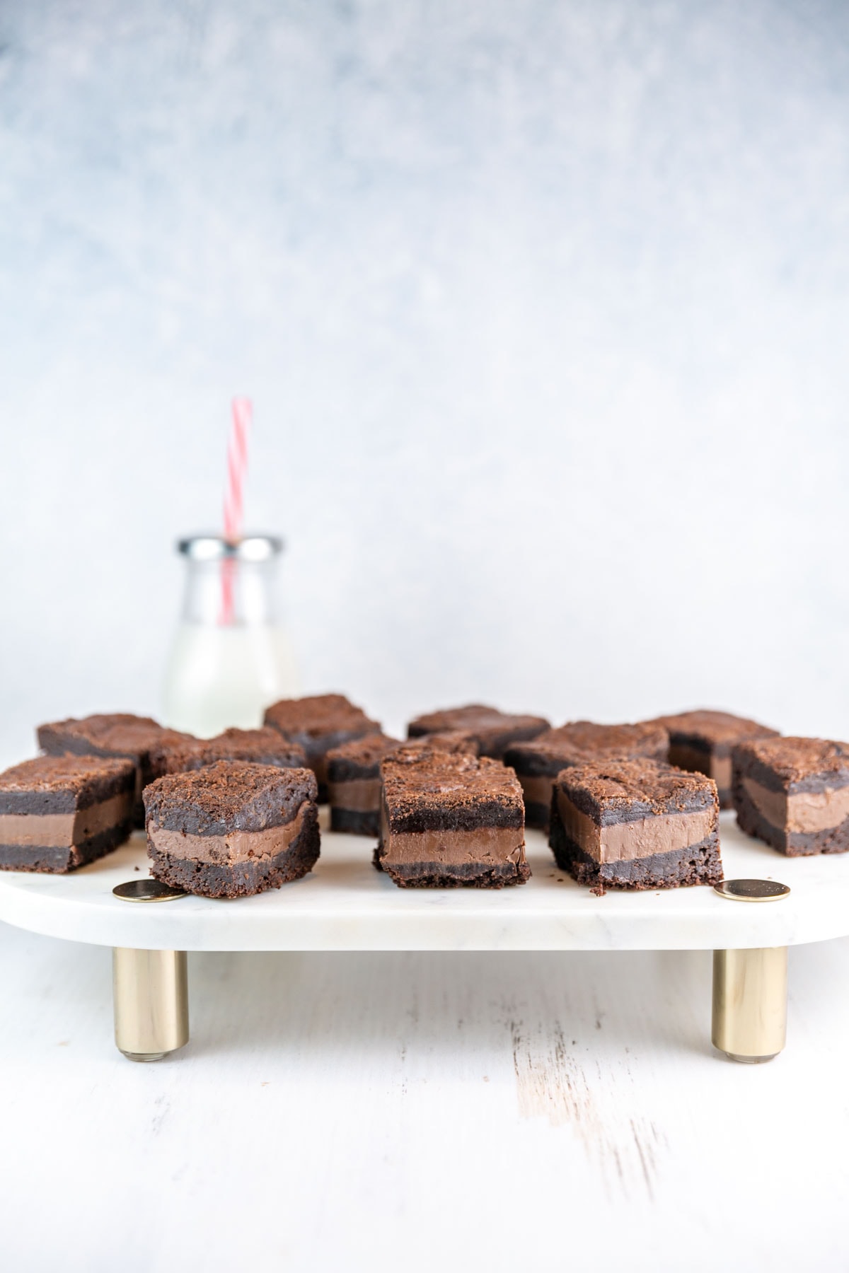 nutella stuffed brownies with a thick layer of nutella on a marble serving board