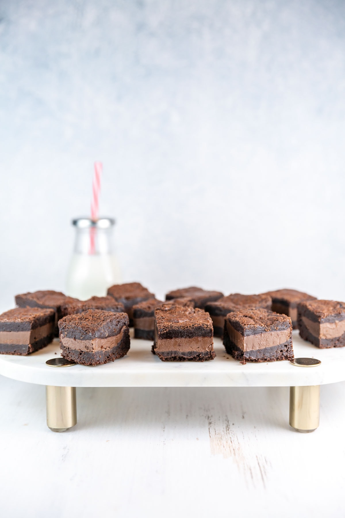 nutella stuffed brownies with a thick layer of nutella on a marble serving board 