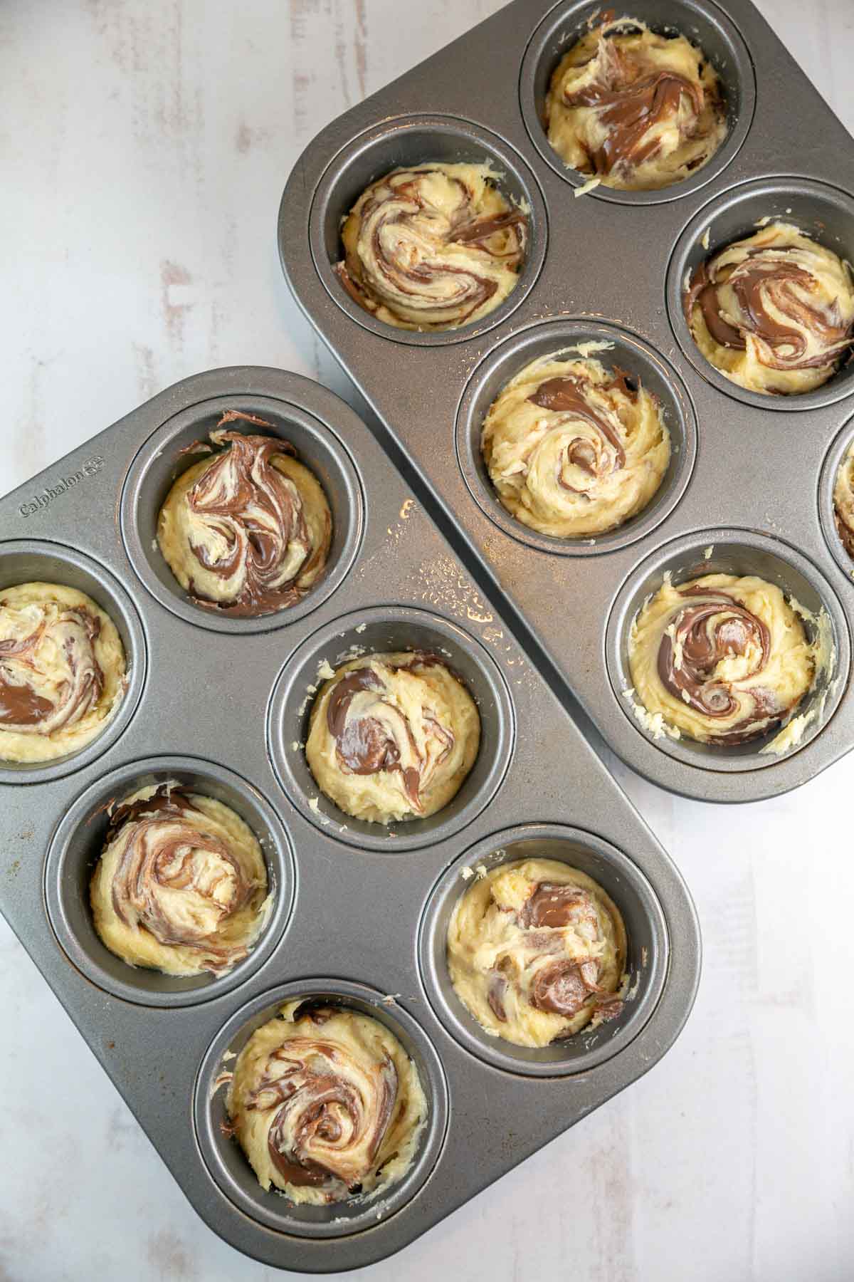 swirls of Nutella in thick cupcake batter